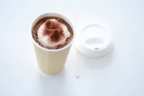 A mug of cocoa with cream in a take away cup — Stock Photo