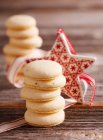 Macarons parts stacked on table with christmas decoration — Stock Photo