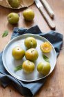 Fresh green pears in a bowl on a white plate — Stock Photo