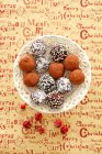 Chocolate truffles with coconut shavings, cocoa powder and sugar beads — Stock Photo