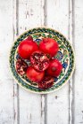 Pomegranates, whole and cut open — Stock Photo