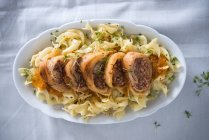 Cabbage rolls stuffed with beef on pasta with red vegetable sauce (vegan) — Stock Photo