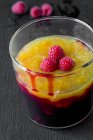 Cherry porridge with mango, peach, and pomegranate in glass — Stock Photo