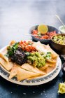 Home made nachos with four toppings — Stock Photo