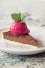 A slice of chocolate tart with raspberry sorbet — Stock Photo