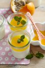 Coconut panna cotta with passion fruit sauce in jars — Stock Photo