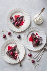 Chocolate, amaretto and cherry brownie with cream and fresh cherries, sliced — Stock Photo