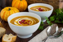 Cream of pumpkin soup with pomegranate seeds — Stock Photo