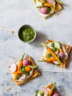Puff pastry tart with lemon feta and cream cheese spread, roasted baby carrots, radishes and carrots — Stock Photo