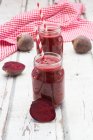 Beetroot smoothies in jars with straws — Stock Photo