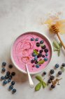 Blackberry and blueberry smoothie bowl with honey — Stock Photo