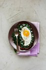 Fried egg sandwich with rye bread, kale and feta cheese on concrete background — Stock Photo