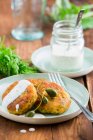 Smoked salmon cakes with capers and yoghurt dip - foto de stock