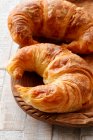 Two croissants in a wooden bowl — Stock Photo