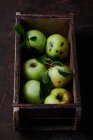 Fresh green apples in a wooden box — Stock Photo