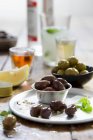 Marinated olives, lemon and drinks — Stock Photo