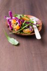 A rocket and red cabbage salad with nuts, wheat and tangerines — Stock Photo