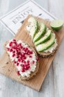 Seeded bread slices with cottage cheese, pomegranate seeds and avocado — Stock Photo