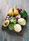 Various vegetables with pears on a wooden tray — Stock Photo