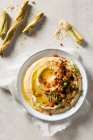 Chickpea hummus dip with basil breadsticks — Stock Photo