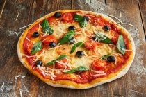 Pizza Milano on wooden background closeup — Stock Photo