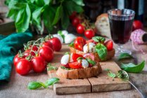 Bruschettas with mozzarella, tomatoes and pesto — Stock Photo