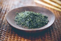 Loose green tea on a plate — Stock Photo