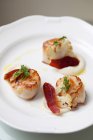 Pan fried scallops with bacon and cauliflower served on a plate — Stock Photo