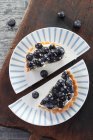 Berry tartlet on two halves of plates — Stock Photo