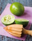 Cut lime and whole one with wodden rimmer — Fotografia de Stock