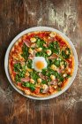Close-up shot of delicious Pizza Popeye with spinach and egg — Stock Photo