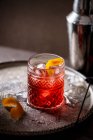 Negroni cocktail (vermouth, gin and campari) with orange zest — Stock Photo