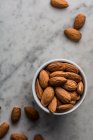 Close-up shot of delicious Almonds on marble surface — Stock Photo