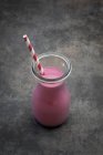 A blueberry smoothie in glass with straw — Stock Photo