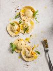 Homemade pumpkin ravioli tortelloni parcels topped with pine nuts, olive oil, rocket and chilli — Stock Photo