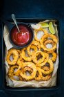 Airfried onion rings with tomato plum sauce — Stock Photo