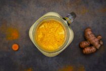 Jar of turmeric and lemon on a white background — Stock Photo