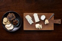 Cheese board with a variety of crackers — Stock Photo