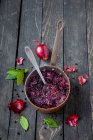Homemade beetroot soup and spoon, on wooden background — Stock Photo