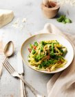 Tagliatelle con broccoli e prosciutto servite sul piatto — Foto stock