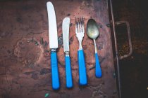 Kitchen utensils and cutlery on a wooden background — Stock Photo