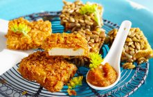 Breaded tofu snacks with cornflakes and sunflower seeds - foto de stock