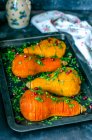 Baked pumpkin halves with olive oil and parsley — Stock Photo