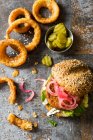 Veggie Vegan Burger made with cauliflower beans and pickled red onions and fried onion rings — Stock Photo
