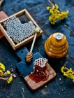 Honeycomb and a honey dipper — Stock Photo