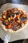Eggplant pizza with mushrooms, olives, red pepper, red onion and roasted carrot topping — Stock Photo
