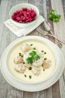 Meatballs in a white sauce with capers served with a beetroot and apple salad — Stock Photo