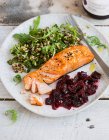 Pan fried salmon topped with Nigella onion seeds, quinoa salad and beetroot marmalade chutney — Stock Photo