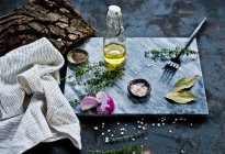 Raw homemade garlic and rosemary on dark rustic table with copy space — Stock Photo