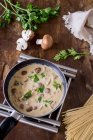 Cream of mushroom sauce with parsley in a pan — Stock Photo